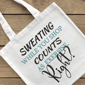 May include: White canvas tote bag with black text that reads "Sweating while you shop counts as exercise. Right?"