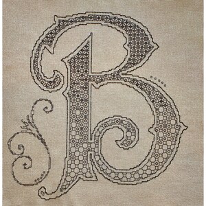 May include: A black embroidered letter B on a beige fabric background. The letter is in a decorative font with swirls and flourishes.