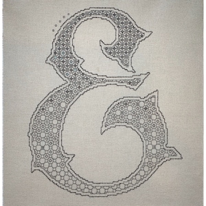 May include: Black and white cross-stitch pattern of the letter "E" with a decorative, ornate design.