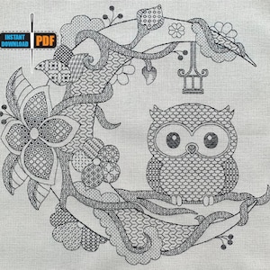 May include: Black and white embroidery design of an owl perched on a branch with flowers and a hanging lantern. The design is intricate and detailed, with a variety of stitches and patterns.