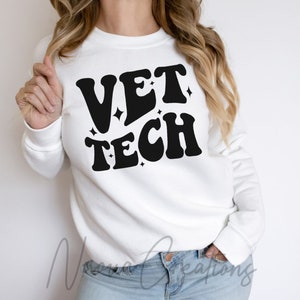 May include: White sweatshirt with black text that reads "VET TECH" in a retro font with sparkling accents.