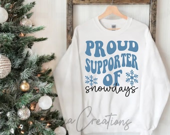 May include: White sweatshirt with blue text that reads "Proud Supporter of Snowdays" with two snowflake graphics.