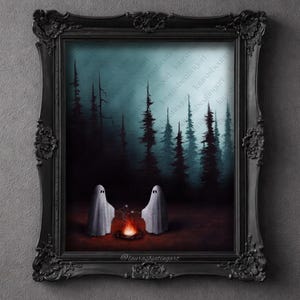 May include: A framed artwork depicts two ghost figures gathered around a campfire in a dark forest. The painting features a dark color palette with a spooky, atmospheric feel. The frame is ornate and black.