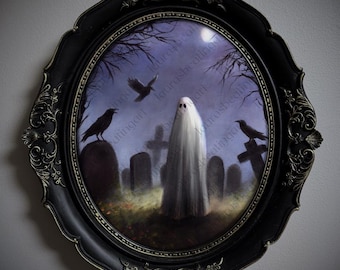May include: An oval wall art piece featuring a white ghost standing in a graveyard at night with black ravens, tombstones, and bare trees under a full moon. The artwork is encased in an ornate, scalloped black frame with gold-toned detailing.