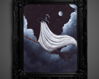 May include: A framed painting depicts a ghost wearing a witch hat, riding a broom through a night sky with a full moon and stars. The ghost is draped in a white sheet, and the artwork is set in a black ornate frame.