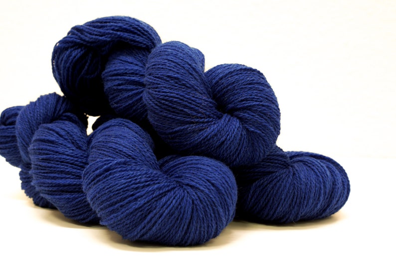 May include: A pile of deep blue yarn skeins, perfect for knitting or crocheting projects.
