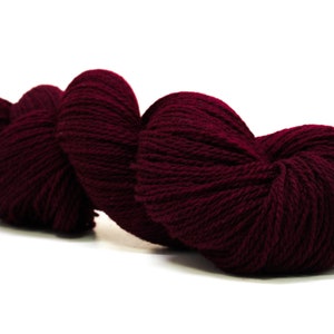 May include: A skein of deep burgundy yarn, perfect for knitting or crocheting.