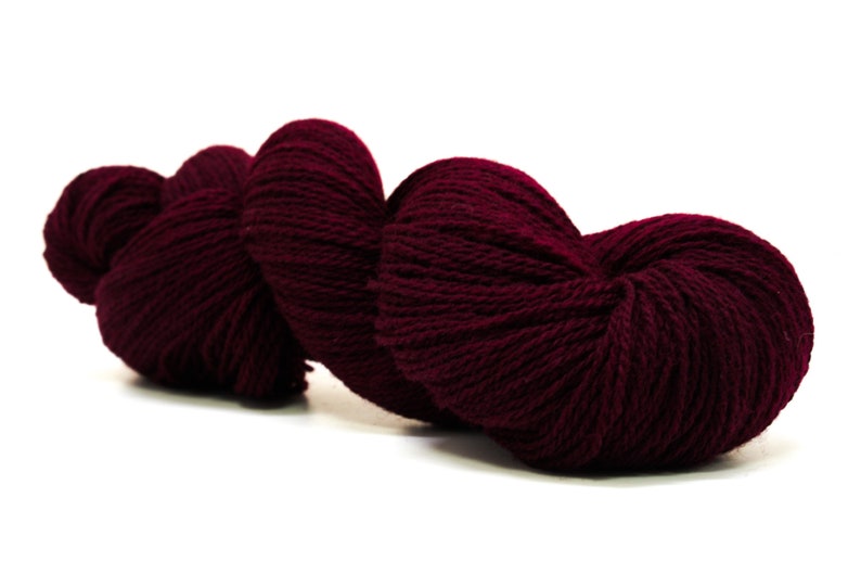 May include: A skein of deep burgundy yarn, perfect for knitting or crocheting.