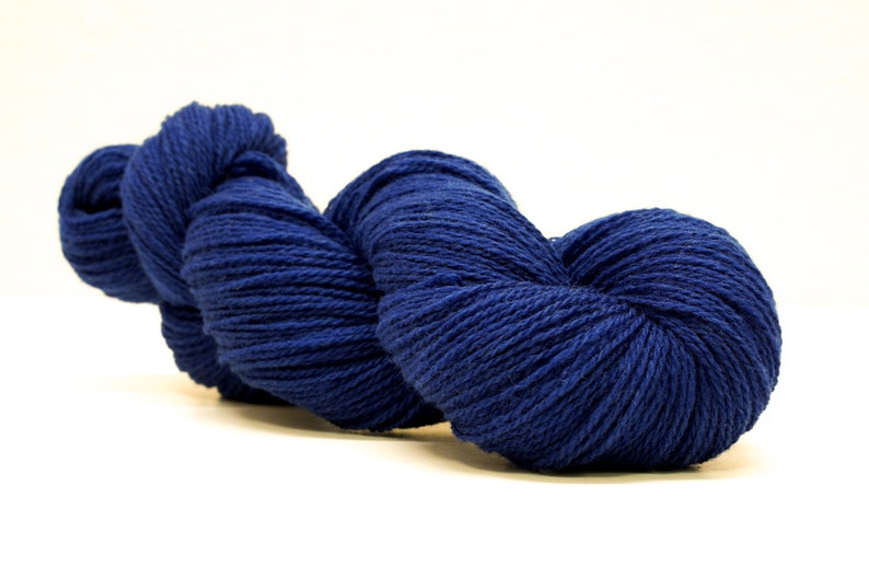 May include: A skein of deep blue yarn, wound into a heart shape.