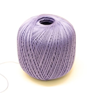 May include: A ball of lavender yarn with a long strand of yarn extending from it.
