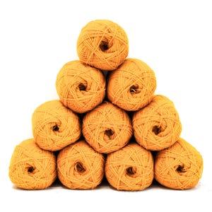 May include: A pyramid arrangement of ten round balls of golden yellow yarn. Each ball features a textured, wound fibre construction with a visible centre opening. The yarn is uniform in colour and shape, stacked in a stable triangular formation.