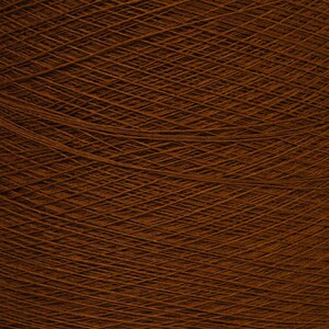 May include: Close-up of a large ball of brown yarn. The yarn is tightly wound, creating a dense, textured surface. The color is a rich, warm brown, with visible strands crisscrossing to form a complex pattern. Ideal for knitting and crochet projects.
