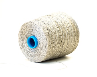 May include: A spool of beige yarn with a blue plastic center.