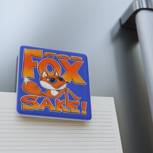 "For Fox Sake" ceramic gift magnet with cute, blue-eyed, foxy lady with funky fun cartoon words that are human-drawn by RandomFox, Kim Teems Fox.