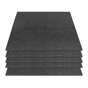 May include: A stack of six black cardboard cake circles with a decorative embossed pattern. The circles are designed for supporting and decorating cakes.