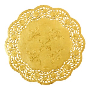 May include: Gold-colored paper doily with a scalloped edge and a floral design. The doily has a delicate lace pattern and is perfect for adding a touch of elegance to any occasion.