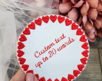 May include: White round fabric patch with a red heart border. The center of the patch has the text "Custom text up to 20 words".