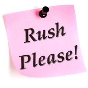 May include: A pink sticky note with a black push pin attached to the top. The note says "Rush Please!" in black cursive writing.