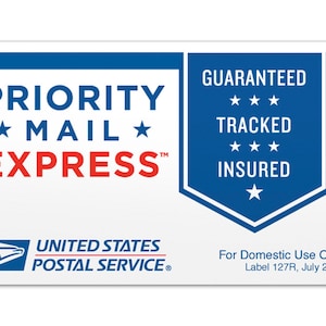 May include: A blue and white Priority Mail Express label with the text "PRIORITY MAIL EXPRESS" in red and white. The label also includes the text "GUARANTEED TRACKED INSURED" in white on a blue background.