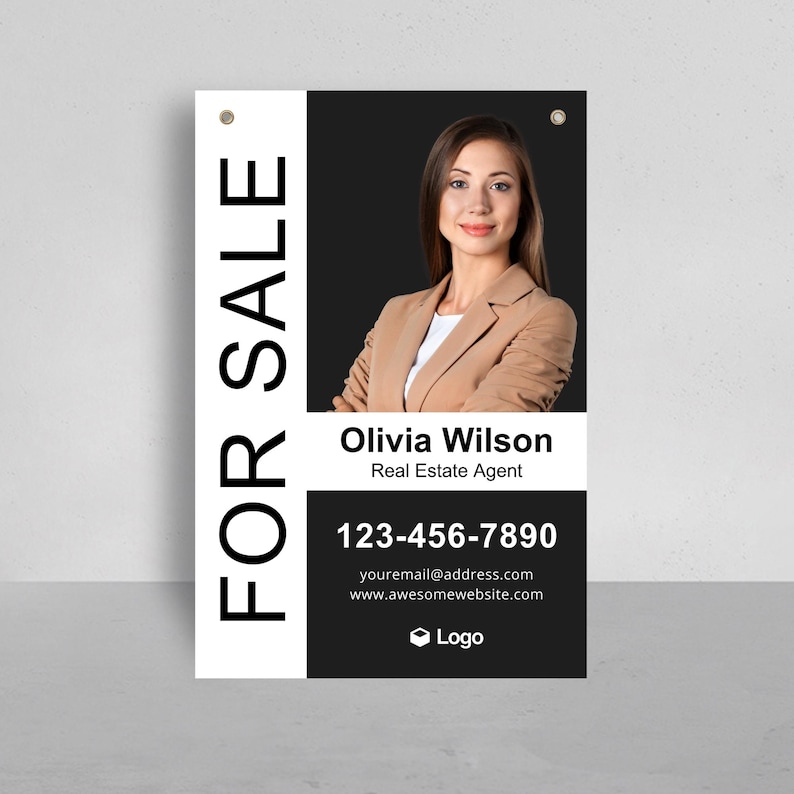 May include: A rectangular real estate sign featuring the text FOR SALE in large vertical letters. It displays a photograph of a person in a tan blazer, the name Olivia Wilson, the title Real Estate Agent, phone number 123-456-7890, and email.