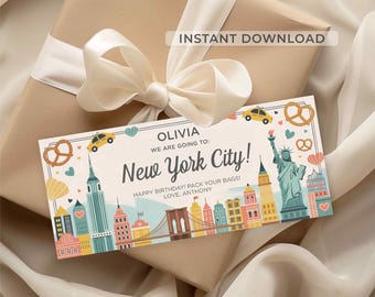 May include: A gift tag with a New York City theme, featuring illustrations of iconic landmarks like the Statue of Liberty and the Empire State Building. The tag is on a wrapped gift with a cream-colored bow. Text includes "New York City!" and "Happy Birthday!"