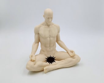 May include: A nude figurine of a person sitting in a meditative pose with legs crossed. The figurine is made of a light beige material and has a smooth finish.