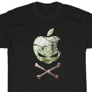 May include: Black t-shirt with a green apple graphic that has a skull and crossbones design. The apple is cracked and has a spiderweb pattern.