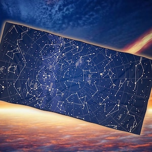 May include: A blue tapestry with a white constellation map printed on it. The constellations are labeled with their names. The tapestry is hanging in front of a sunset sky.