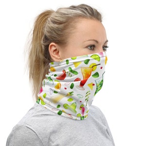 May include: A white face mask with a colorful pattern of tropical cocktails, fruits, and leaves. The mask is made of a soft, breathable fabric and is designed to be comfortable to wear.
