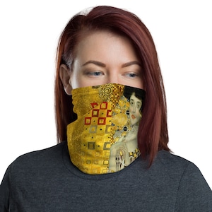 May include: A face mask featuring a painting of a woman with a gold background. The painting is a famous work of art.