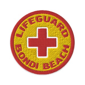 May include: Red and yellow embroidered patch with the words "Lifeguard Bondi Beach" and a red cross in the center.