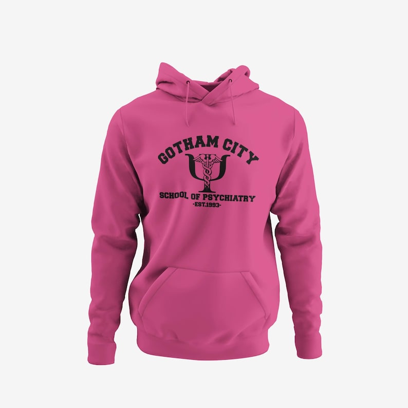 A pink hoodie with the text "GOTHAM CITY SCHOOL OF PSYCHiatry EST. 1970" printed on it.