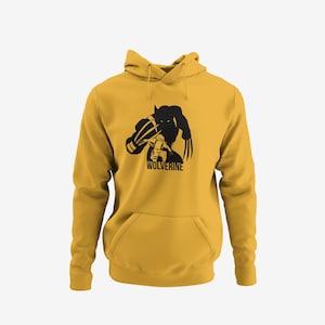 May include: Mustard yellow hoodie featuring a black graphic of Wolverine with his claws extended. The word "WOLVERINE" is printed below the graphic. The hoodie has a drawstring hood and a front kangaroo pocket.