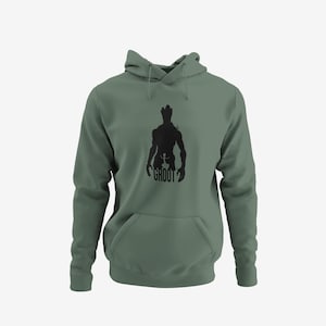 May include: Sage green hoodie with a black silhouette of Groot from Guardians of the Galaxy. The graphic includes the word "GROOT" at the bottom. The hoodie has a drawstring hood and a front kangaroo pocket.