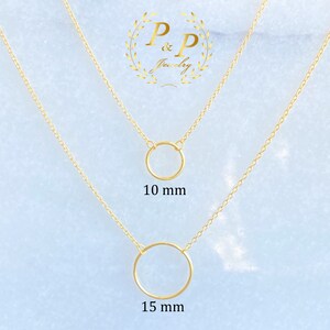 May include: Two gold necklaces with circle pendants. The top necklace has a 10 mm circle pendant and the bottom necklace has a 15 mm circle pendant.  The necklaces are on a light blue background with the text "P&P Jewelry" in a gold wreath.