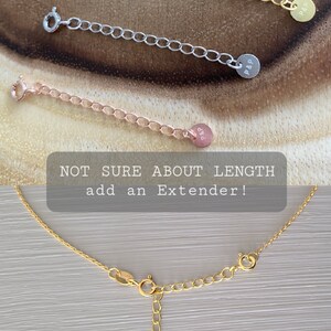 May include: Three gold chain necklace extenders with a small round tag that says "P&P" on each. The text "NOT SURE ABOUT LENGTH add an Extender!" is visible in the image.