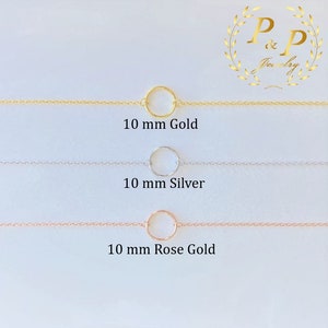 May include: Three delicate gold, silver, and rose gold chains with a 10 mm circle pendant.  The chains are displayed on a white background.