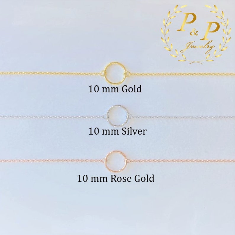 May include: Three delicate gold, silver, and rose gold chains with a 10 mm circle pendant.  The chains are displayed on a white background.