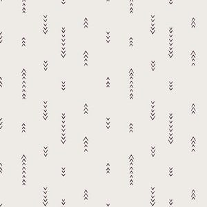 May include: Cream-colored fabric with a repeating pattern of dark brown arrows pointing upwards and downwards. The arrows are arranged in vertical lines and scattered across the surface. The fabric is measured in inches.