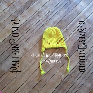 May include: Yellow knitted hat with red stitching in the shape of baseballs. The hat has long ties that can be tied under the chin. The hat is on a wooden background. "PATTERN ONLY" and "6 SIZES INCLUDED" are written on the background. "Honey Bee Knittery Hat Shoppe" is written on the hat.