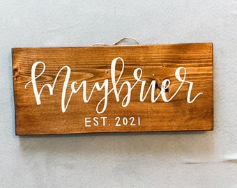 Personalized last name sign with year EST.