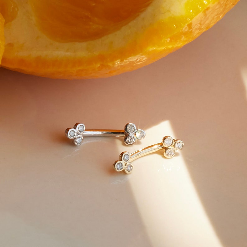 A captivating 14k solid gold trinity piercing adorned with dazzling diamonds, available in both yellow and white gold. Versatile for ear piercings like helix, tragus, or conch, or for adorning other body piercings with elegance and quality.