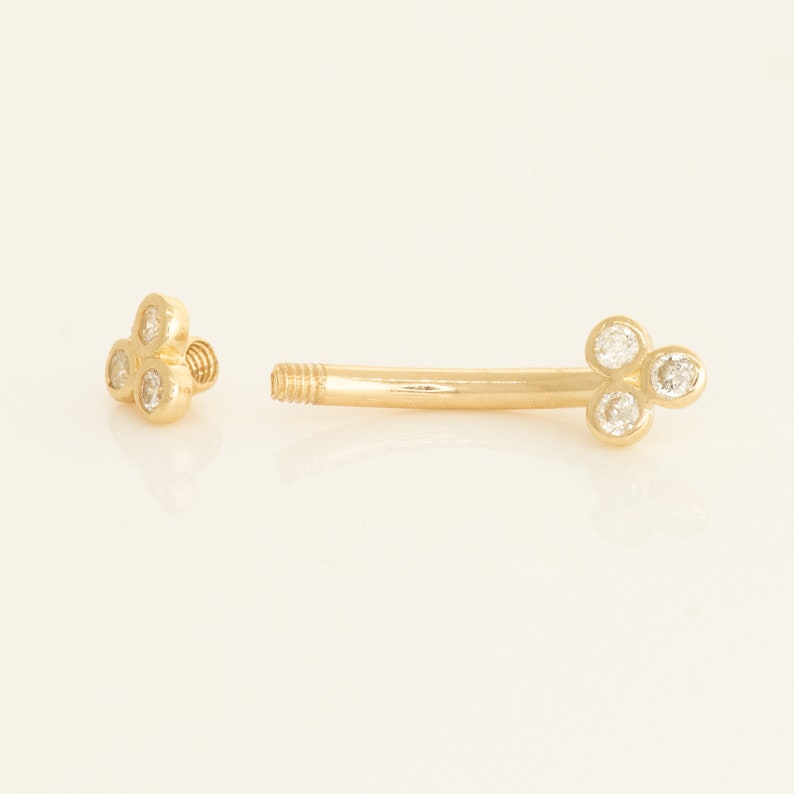 A captivating 14k solid gold trinity piercing adorned with dazzling diamonds, available in both yellow and white gold. Versatile for ear piercings like helix, tragus, or conch, or for adorning other body piercings with elegance and quality.