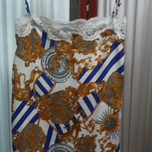 Printed Silk Chemise with white scallop lace. White Background with Blue and gray Lion Print.  Adjustable straps.