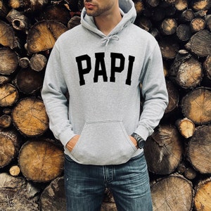 May include: A gray hooded sweatshirt with the word "PAPI" printed in black on the front.