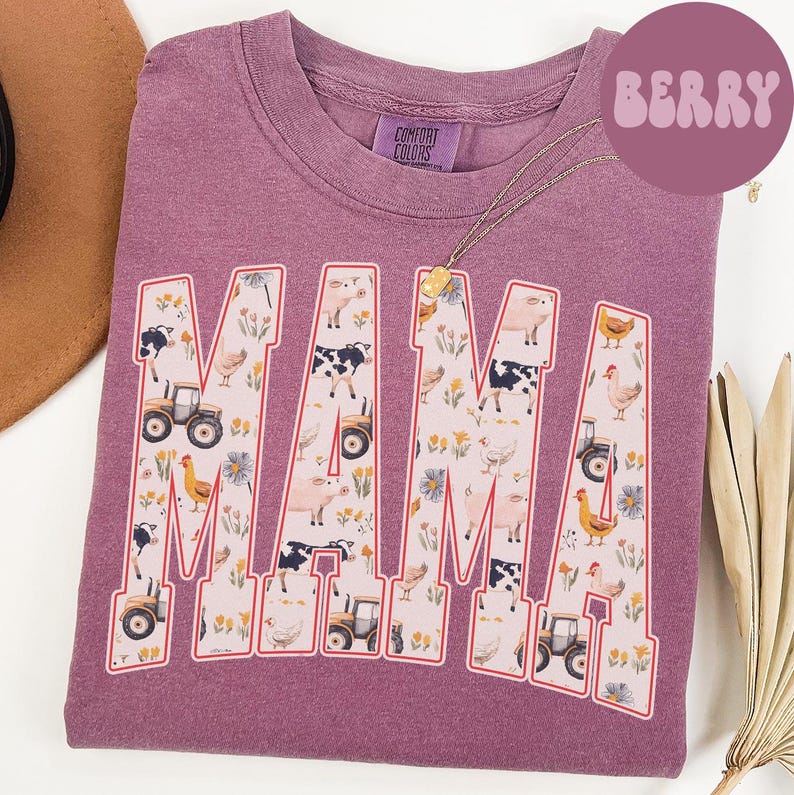 A purple t-shirt with the word "MAMA" printed on it, featuring various farm and animal-themed illustrations.