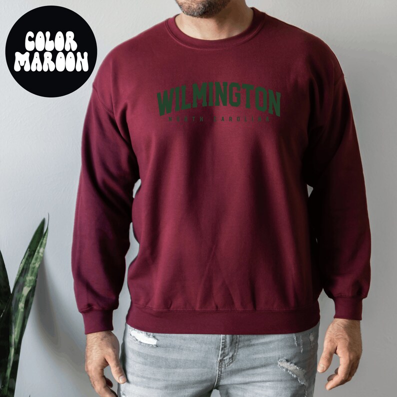 May include: A maroon sweatshirt with the text "WILMINGTON NORTH CAROLINA" in green.