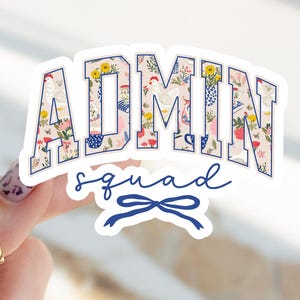 May include: A sticker with the word "ADMIN" in large, blue-outlined letters filled with a floral and chicken pattern. Below, the words "squad" and a blue bow are written in a script font.