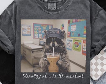 Comfort Colors Health Assistant Raccoon Shirt, School Nursing Student T-Shirt, Back to School, Pediatric Gift, Nurse Week, Appreciation Tee