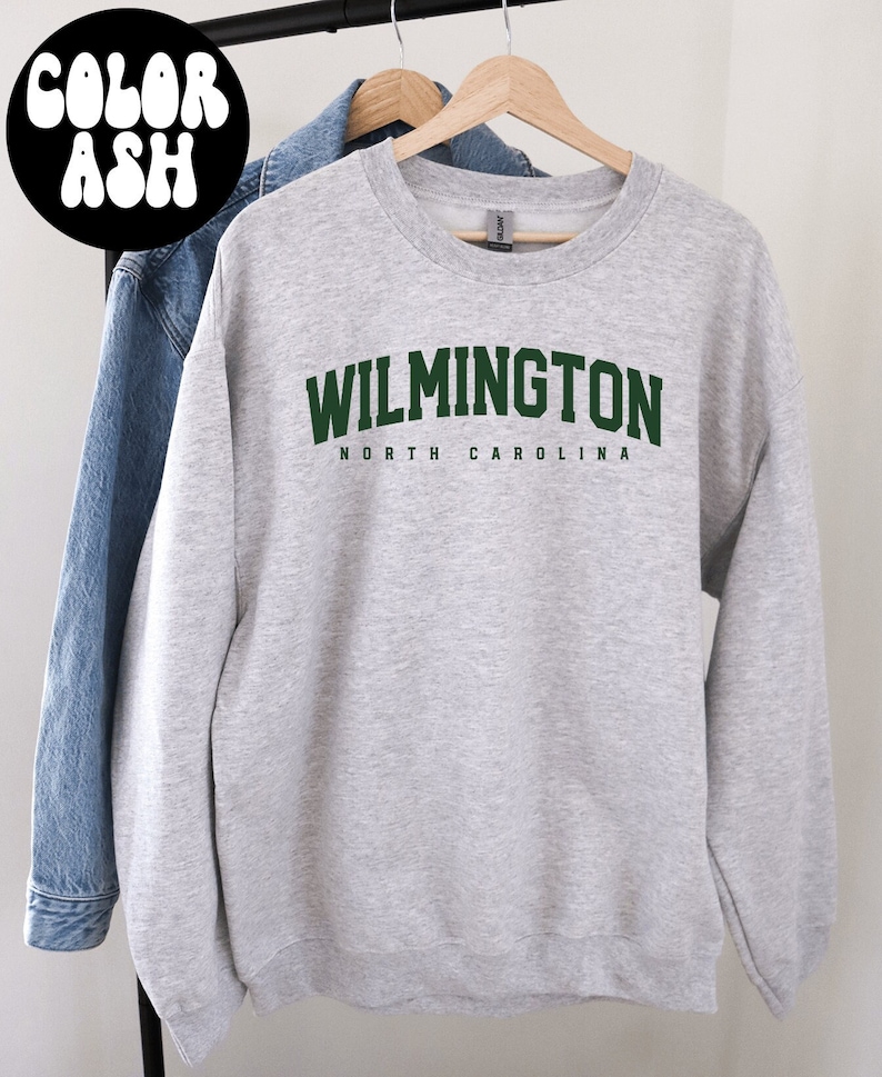 May include: A grey sweatshirt with the text "WILMINGTON NORTH CAROLINA" in green letters.